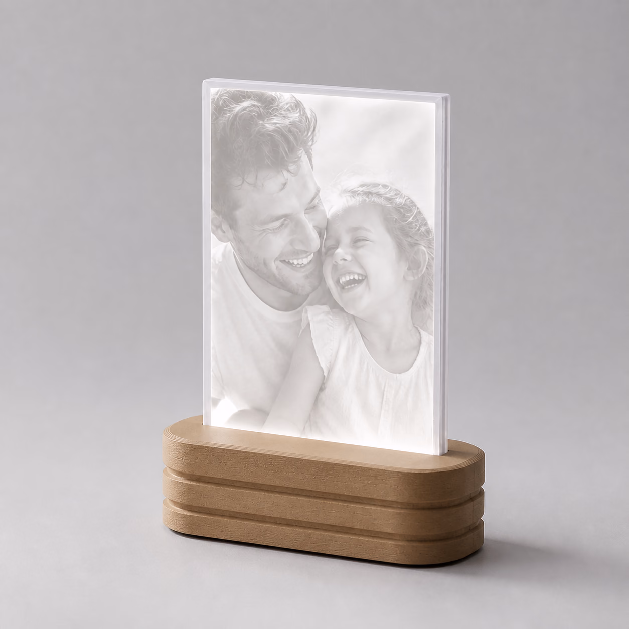 A father and daughter revealed in neutral-white light through a complete Photo Light.